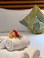 Towels and flowers on a bed in Deluxe Double Rooms at Warwick Club Warwick Fiji Korolevu.