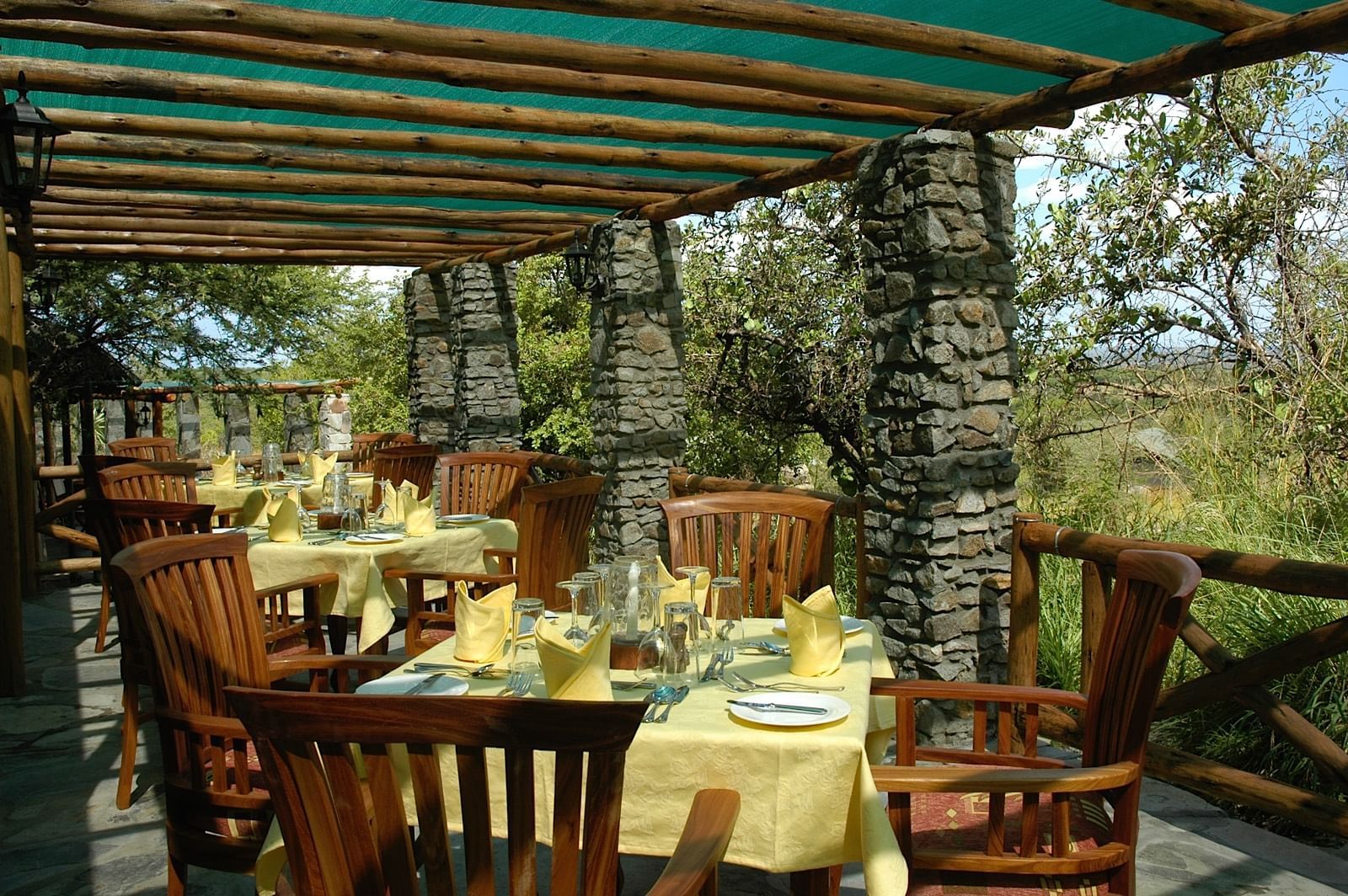 Dining area with arranged tables at Mbuzi Mawe Serena Camp
