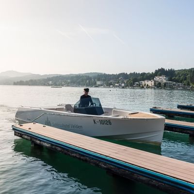 A man on a Motor Yacht by the deck near Falkensteiner Hotels