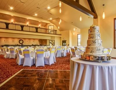 Banquet table arrangement with tiered cake for a wedding in the Augusta Room at Wildwood Hotel