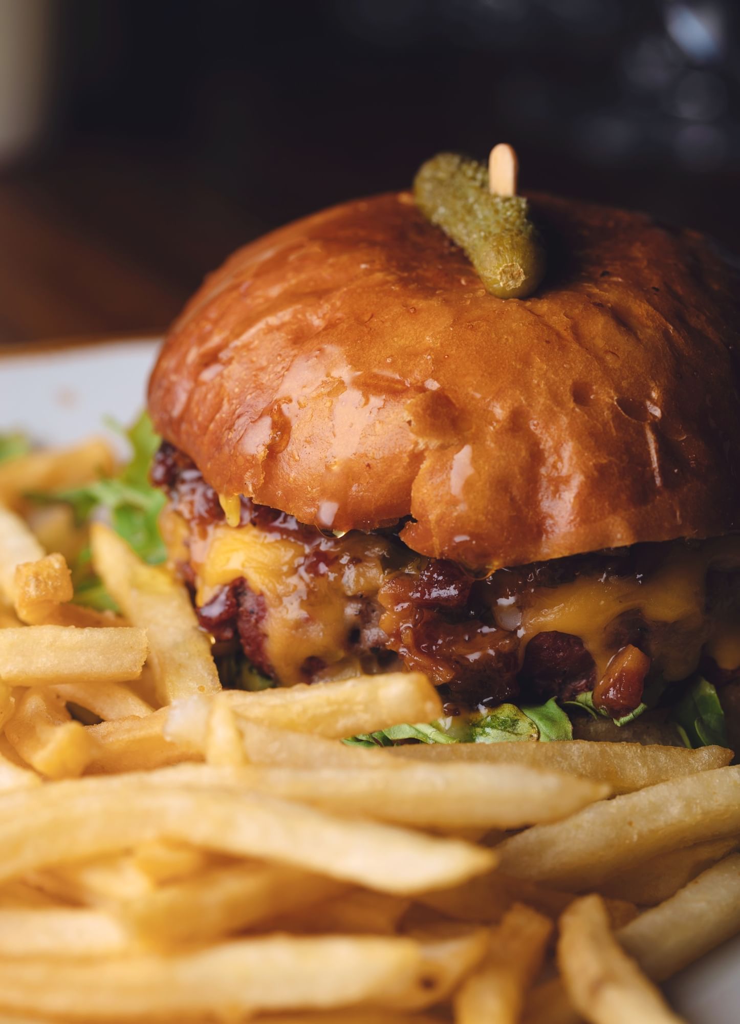 Lorem ipsum Plated cheeseburget and fries with a cornichons on top