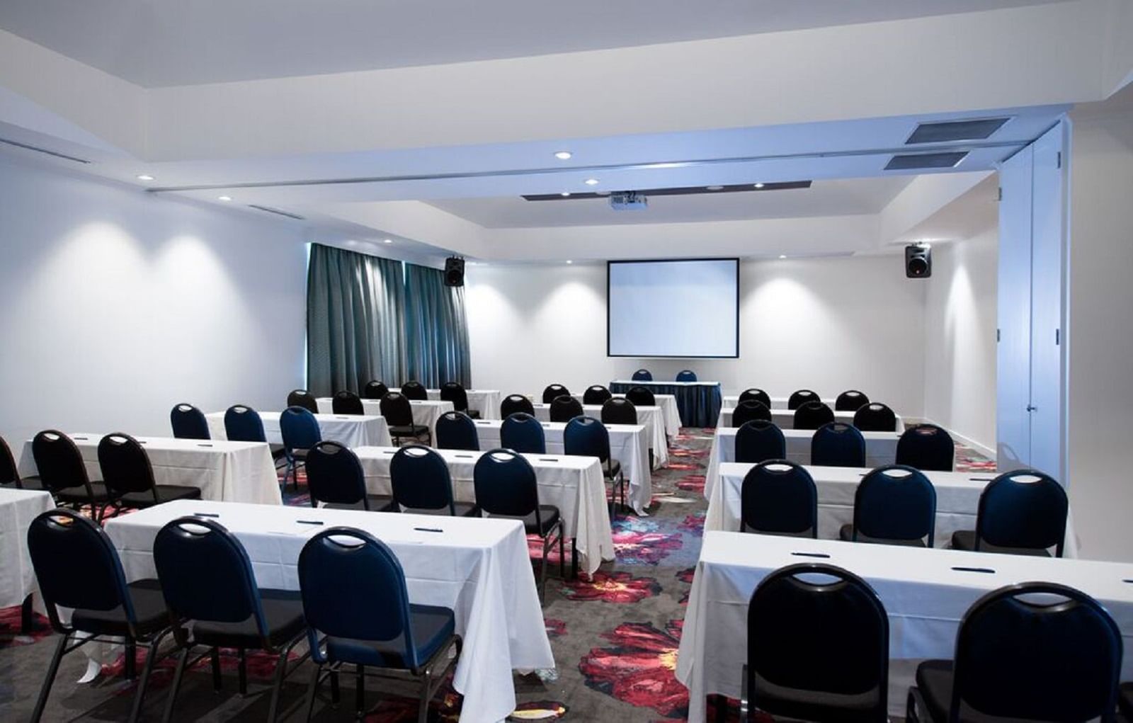 Table setup in Meeting hall with projector at Novotel Barossa