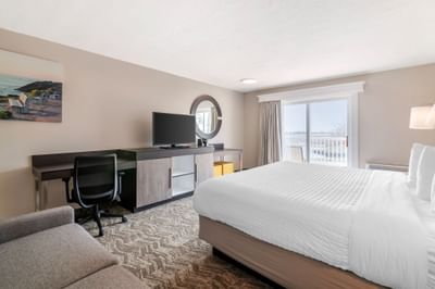 Guest room with bed, desk, and television at Ogunquit River Inn