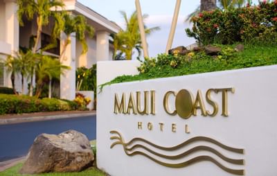 A monument sign of Maui Coast Hotel Kihei on a wall