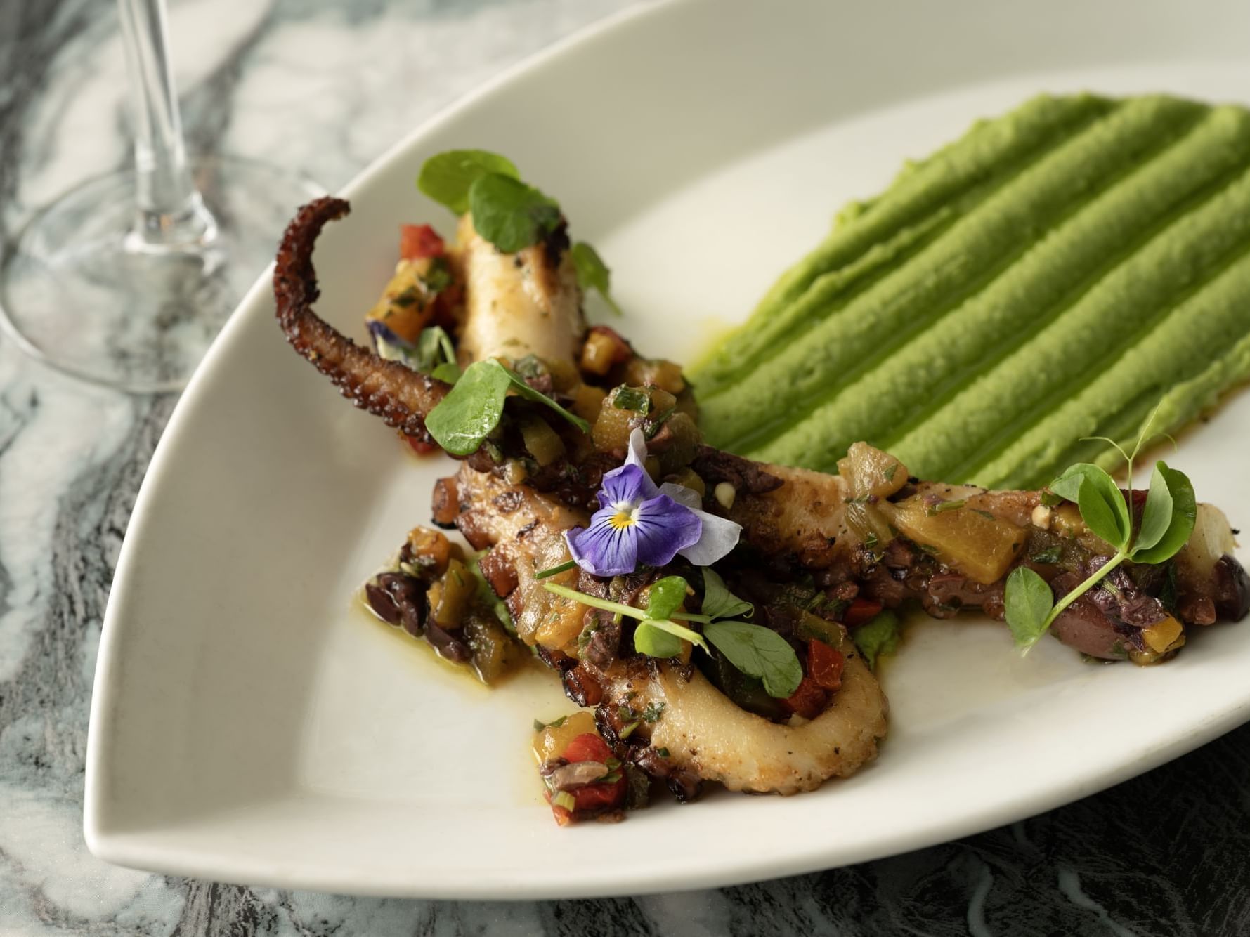 Marinated octopus, green pea hummus, kalamata salad, Calabrian chili