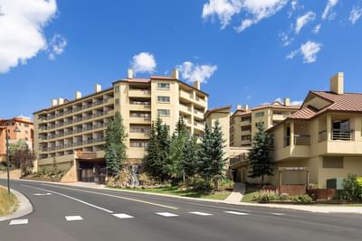 Exterior of Elevation Resort & Spa on a sunny day with blue sky and passing road.