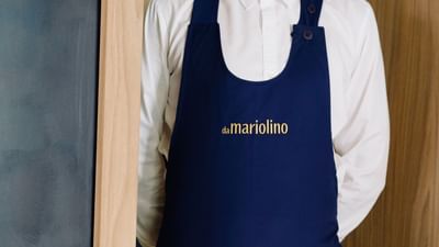 A person wearing an apron with the word 