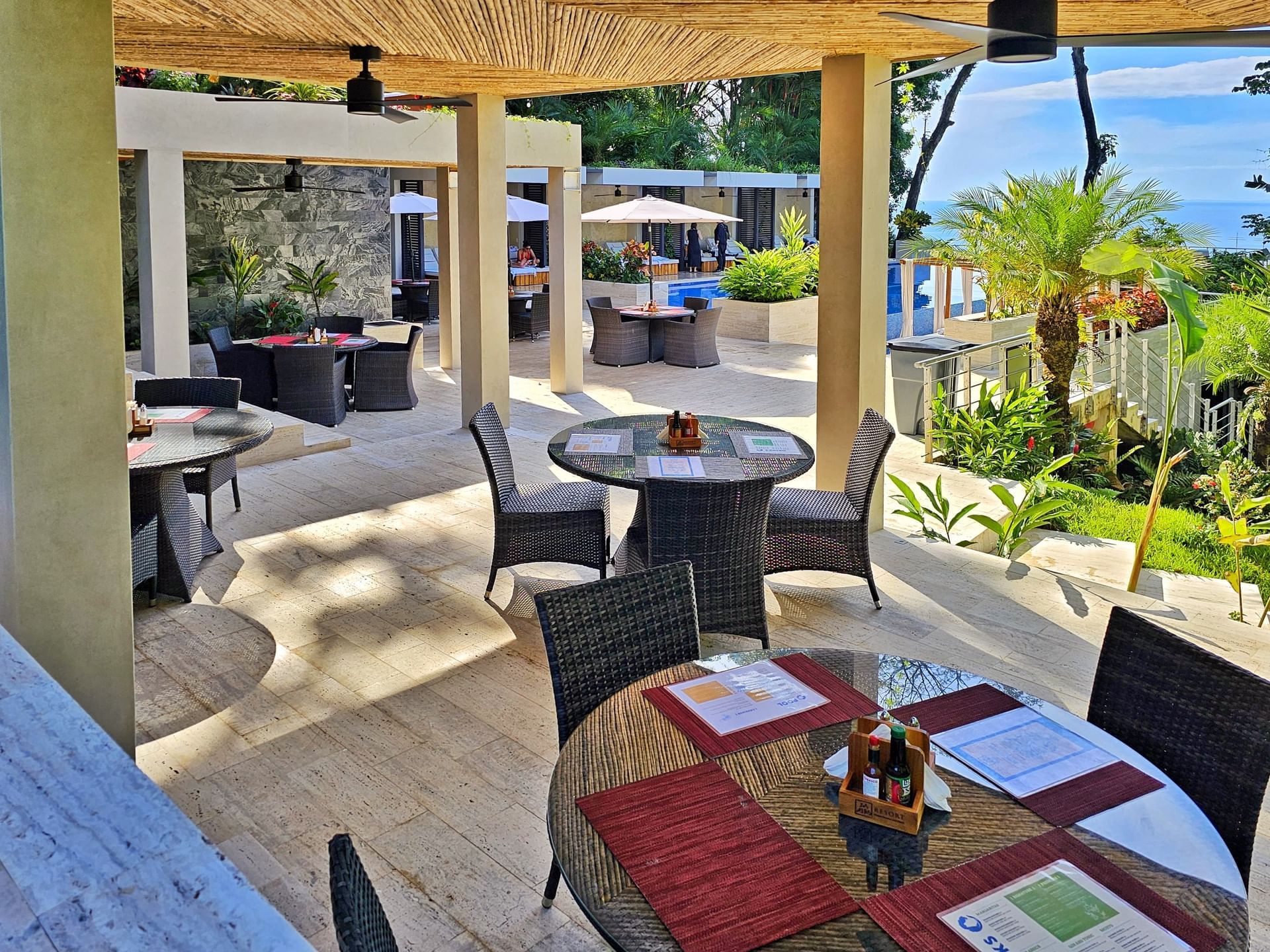 Outdoor dining area arranged in poolside lounge at Los Altos Resort