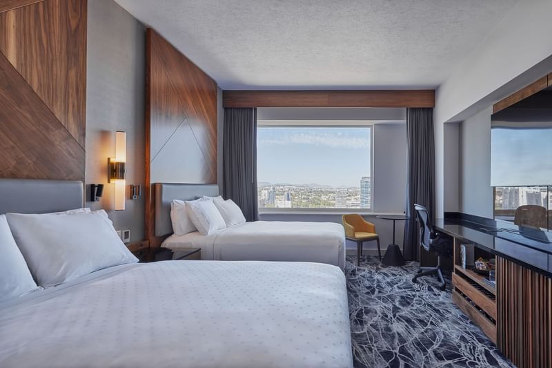 Two beds, work desk & city view in Deluxe Double room at Fiesta Americana Travelty