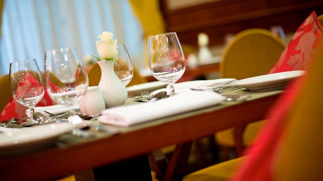 Close-up of a table with glassware arranged in L'auberge Restaurant at Warwick Doha