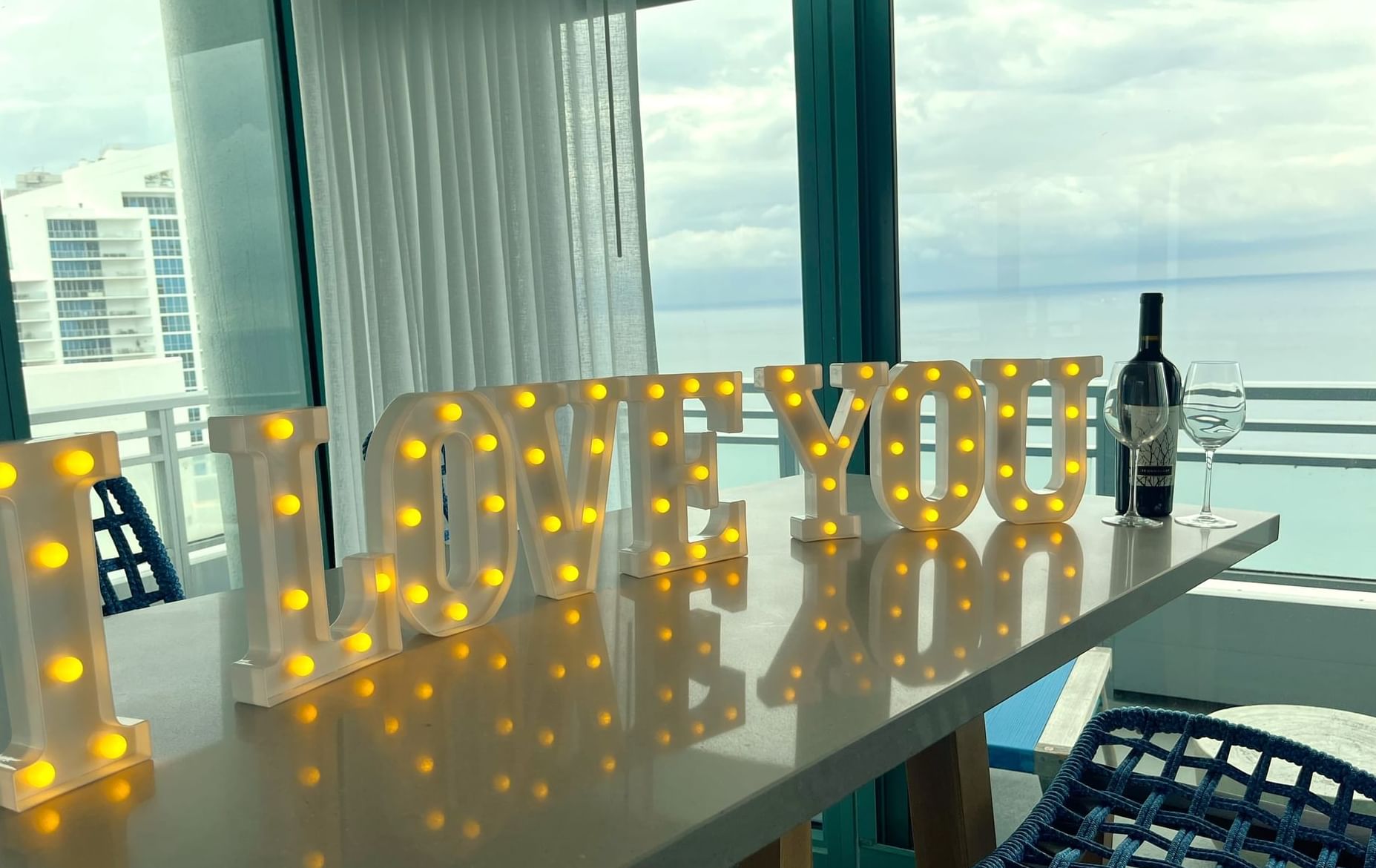 large light up letters spelling I love you on a table with wine for Valentine's Day at Diplomat Resort
