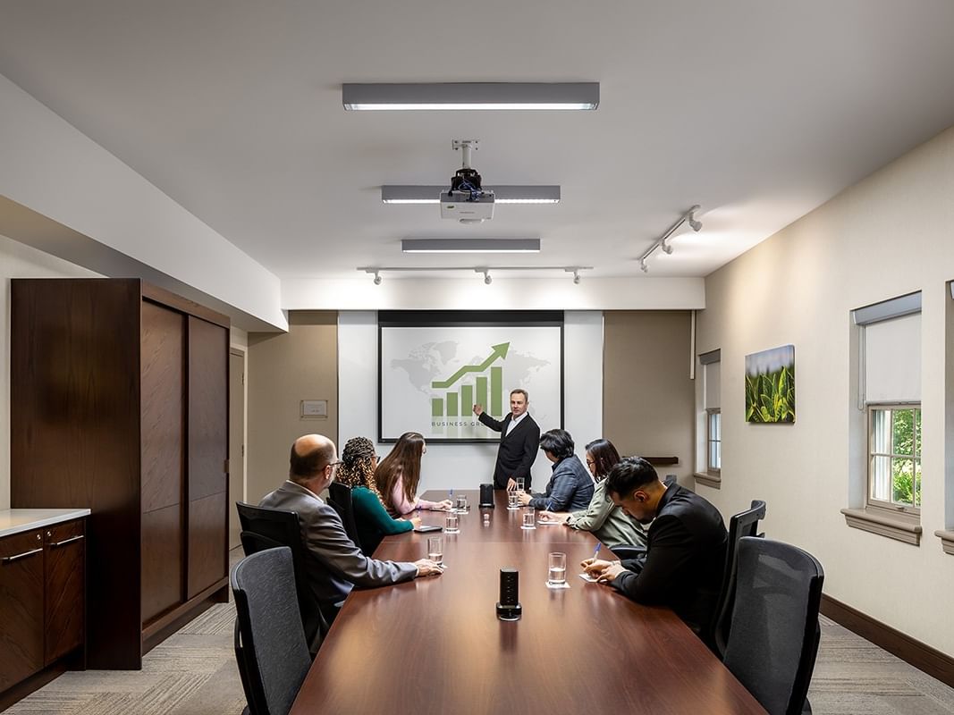 Presenter presenting a chart on screen during a boardroom meeting in FCC Boardroom at pencer Hotel & Conference Centre