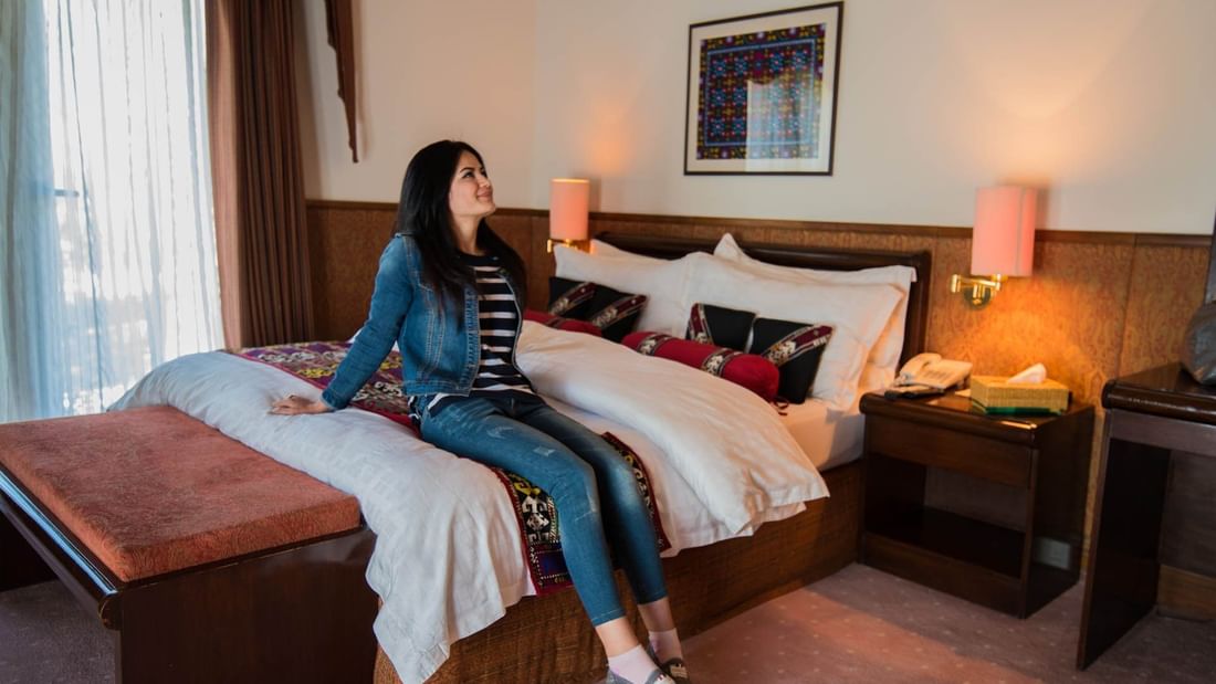 A women relaxing in Standard Twin Bedroom at Khorog Serena Inn