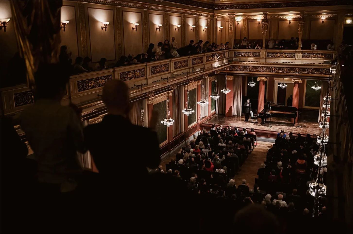 Concert in the Brahms Hall of the Vienna Musikverein with pianist, audience and elegant hall atmosphere
