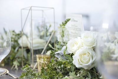 Elegant table setting with white roses and a menu card at Villa Premiere Boutique Hotel & Romantic Getaway