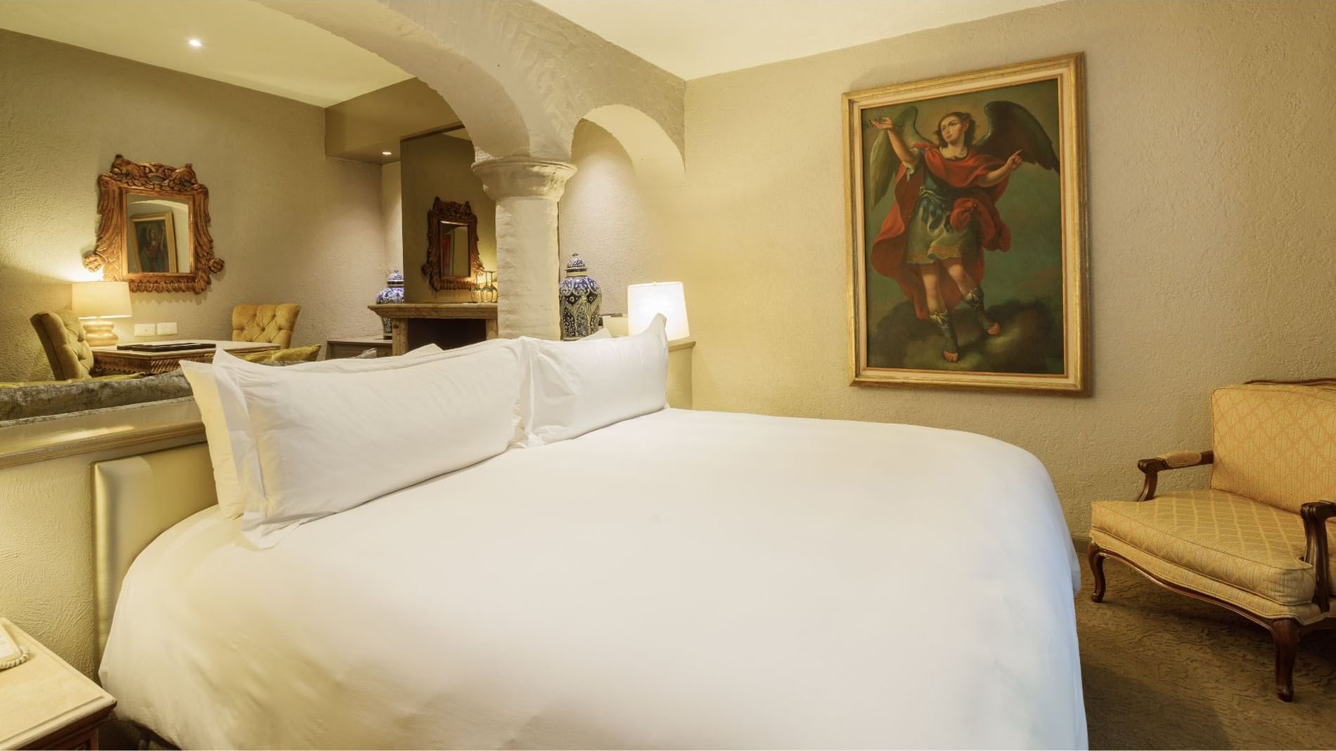 King Governor Suite featuring a bed area with a textured wall, at the Quinta Real Guadalajara