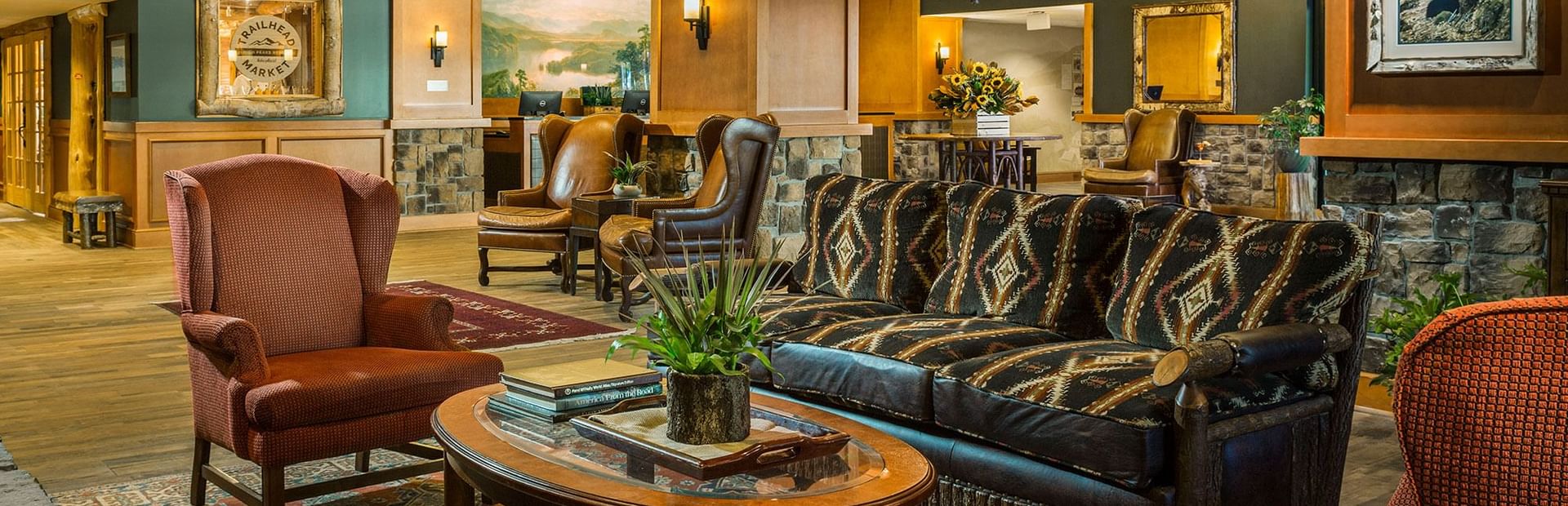 Wide shot of the hotel lobby with multiple seating areas and rustic, lodge-style decor at High Peaks Resort