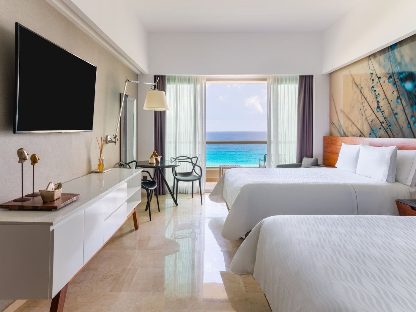 Comfy twin bed faced TV and sitting area in Premium Aqua Club Ocean Front at Live Aqua Beach Resort