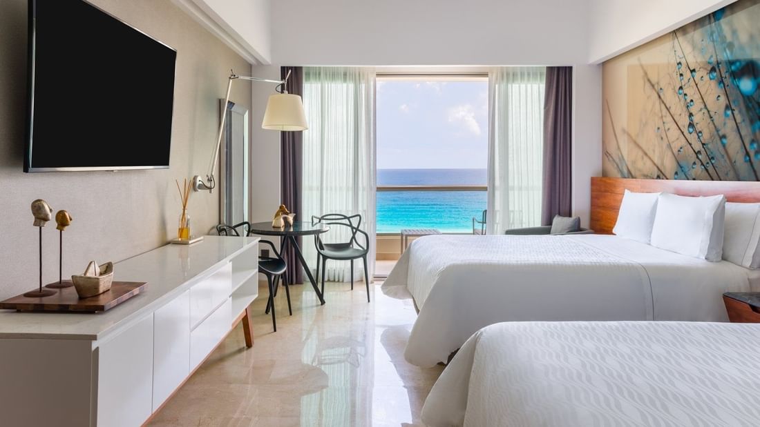 Comfy twin bed faced TV and sitting area in Premium Aqua Club Ocean Front at Live Aqua Beach Resort