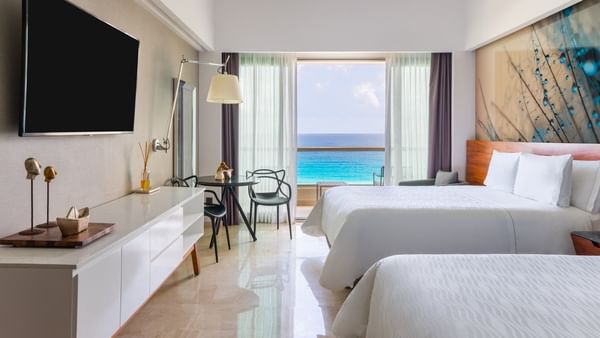 Comfy twin bed faced TV and sitting area in Premium Aqua Club Ocean Front at Live Aqua Beach Resort