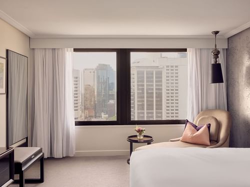Signature Suite Room with a city view through the window, a bed, and modern decor at Sofitel Brisbane Central