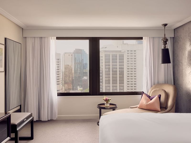 Lounger by the bed in Signature Suite with a city view at Sofitel Brisbane Central