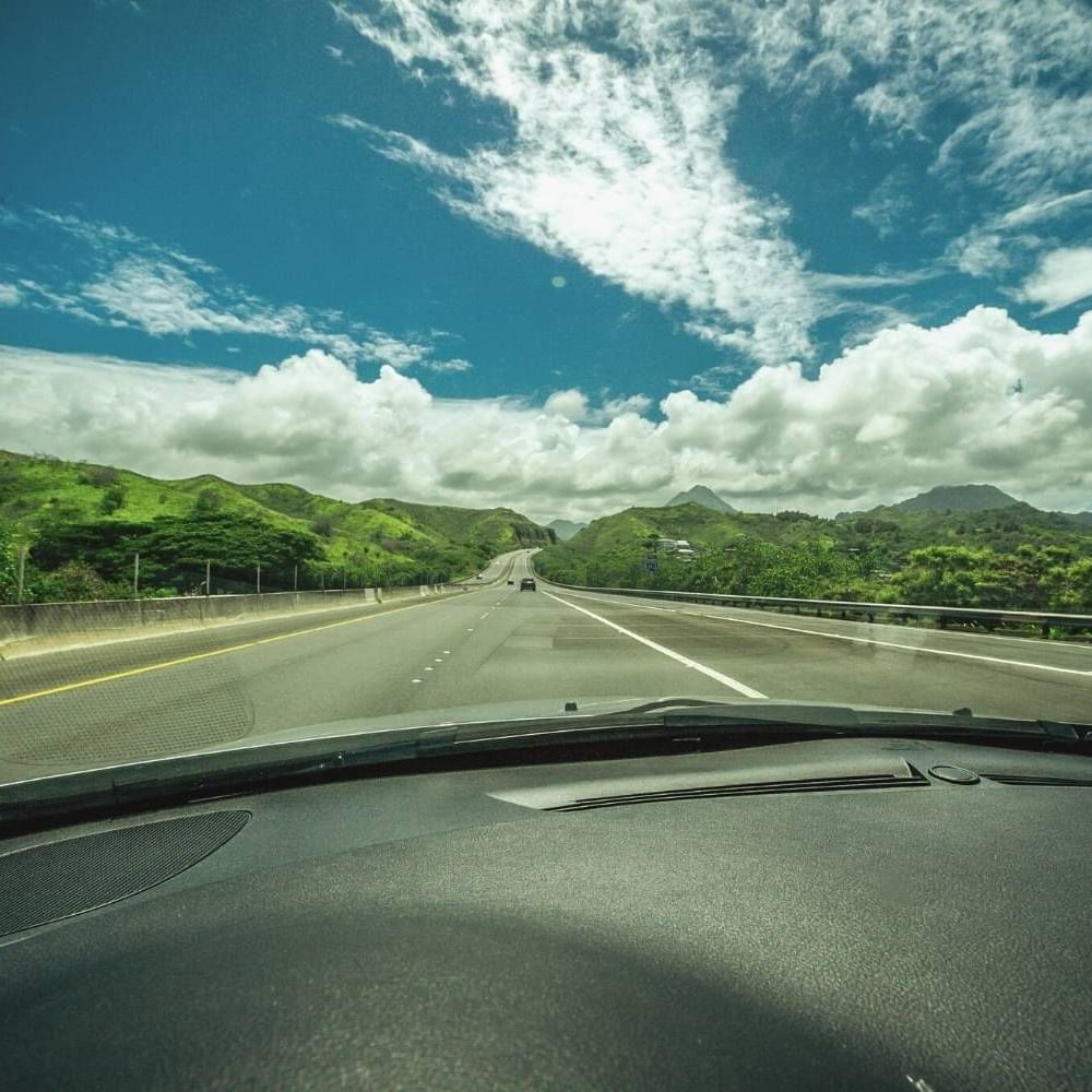 Street view on a sunny day from the car near Waikiki Resort Hotel by Sono