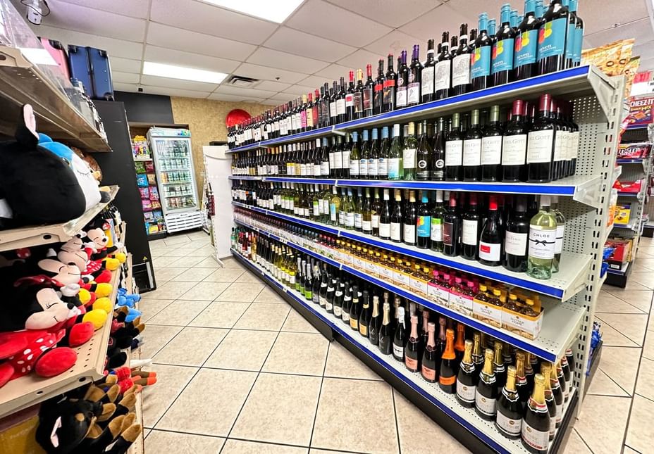 A convenience store with wine and plush toys on shelves