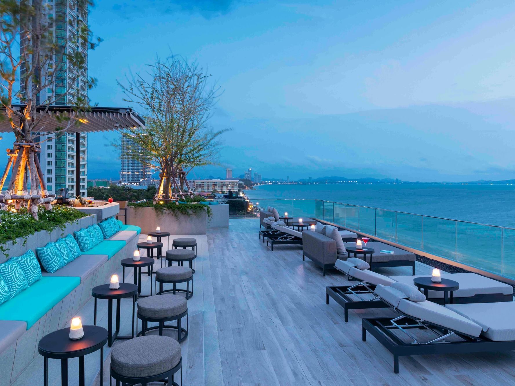Outdoor lounge area with sea view at U Jomtien Hotel