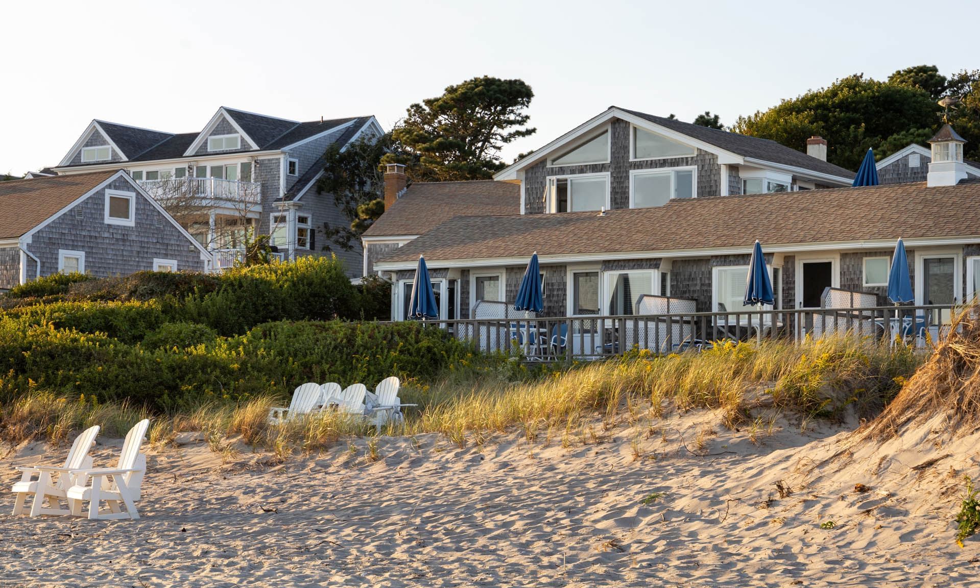 Landscape view of the resort buildings by the seashore arranged with the loungers towards sea at Chatham Tides Resort