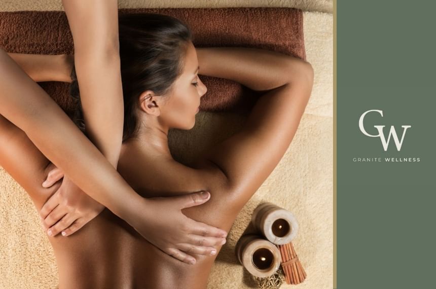 A serene spa moment at Granite Wellness where a woman enjoys a relaxing back massage at The Aberdeen Dyce Hotel