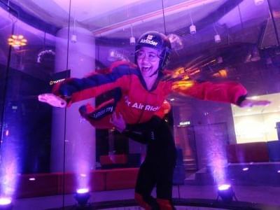 Women leaping in indoor skydiving for vacation getaway in Winlab Indoor Skydiving near One World Hotel