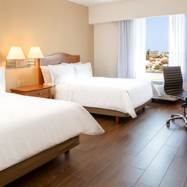 Twin beds with working desk in Superior Room at Fiesta Inn