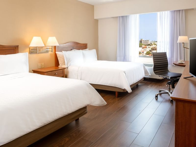 Twin beds with working desk in Superior Room at Fiesta Inn