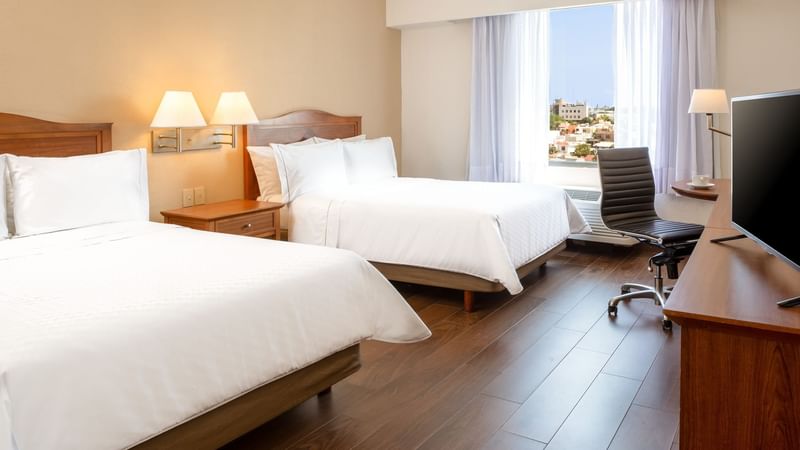 Twin beds & work desk in a guest room at Fiesta Inn Tampico