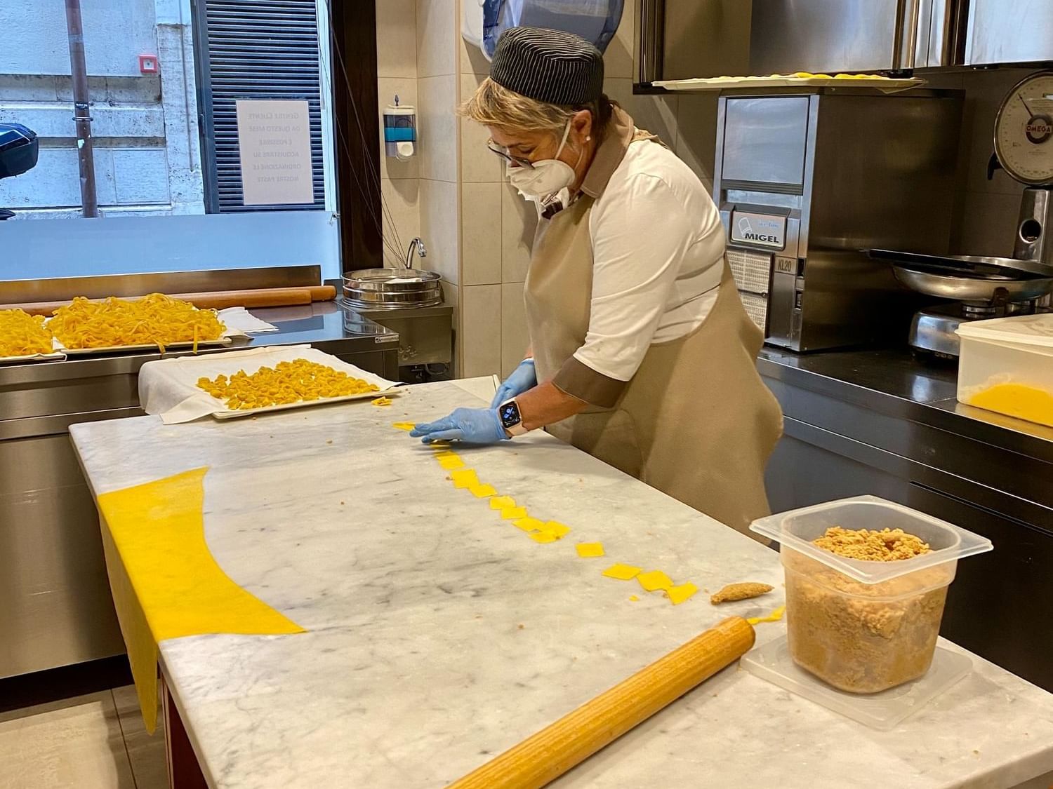 Chef wearing gloves and making pasta in the kitchen at Margutta 54