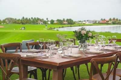 Outdoor dining table set up in front of the golf course at The Hub Acunmeyda