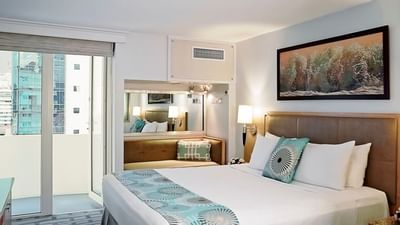 room with bed and door to balcony