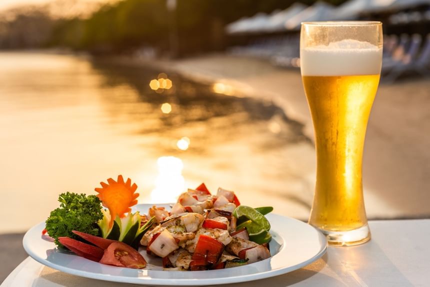 Salad plate served with a beer glass in the outdoor dining area at Hotel Isla Del Encanto