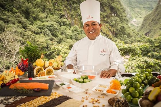 Chef Ribelino Alegria Copia posing by the buffet at Hotel Sumaq