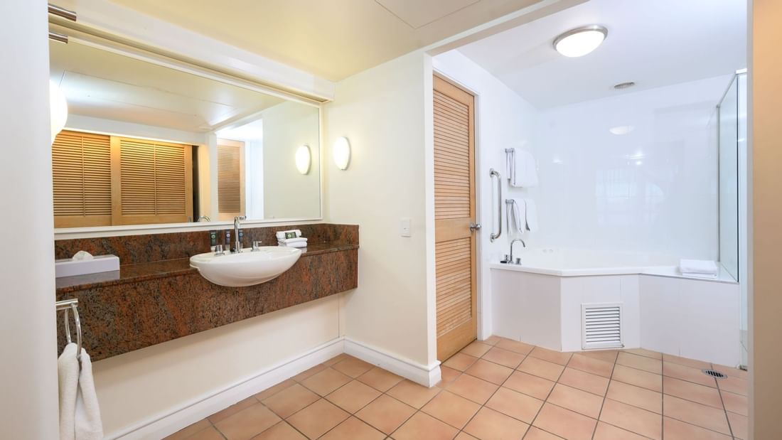 Bathroom vanity with glass shower in One & Two-Bedroom Suites at Novotel Sunshine Coast Resort