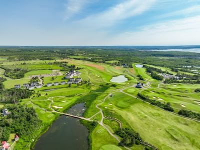 Aerial view of luxury accommodations, PEI, and golf course greens at Rodd Crowbush Golf & Beach Resort