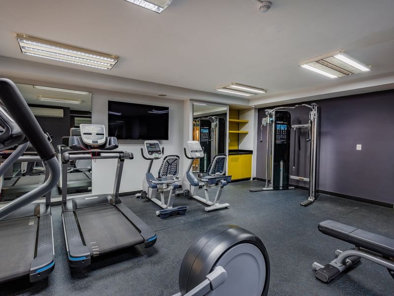 Gym equipment in the fitness center at Gamma Hotels