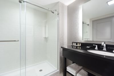 bathroom with shower and black vanity