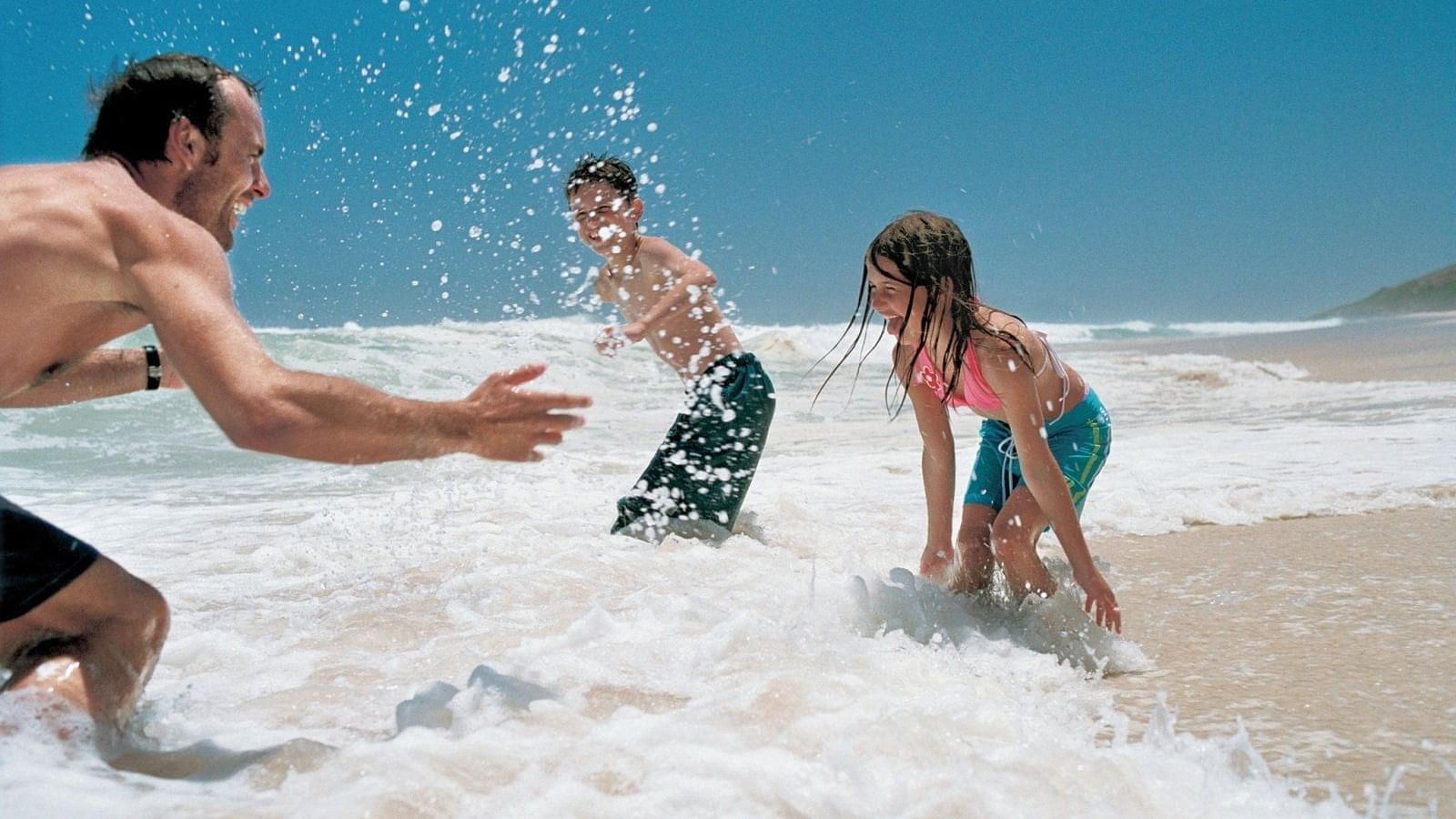 A family enjoying in the beach at Pullman Bunker Bay Resort