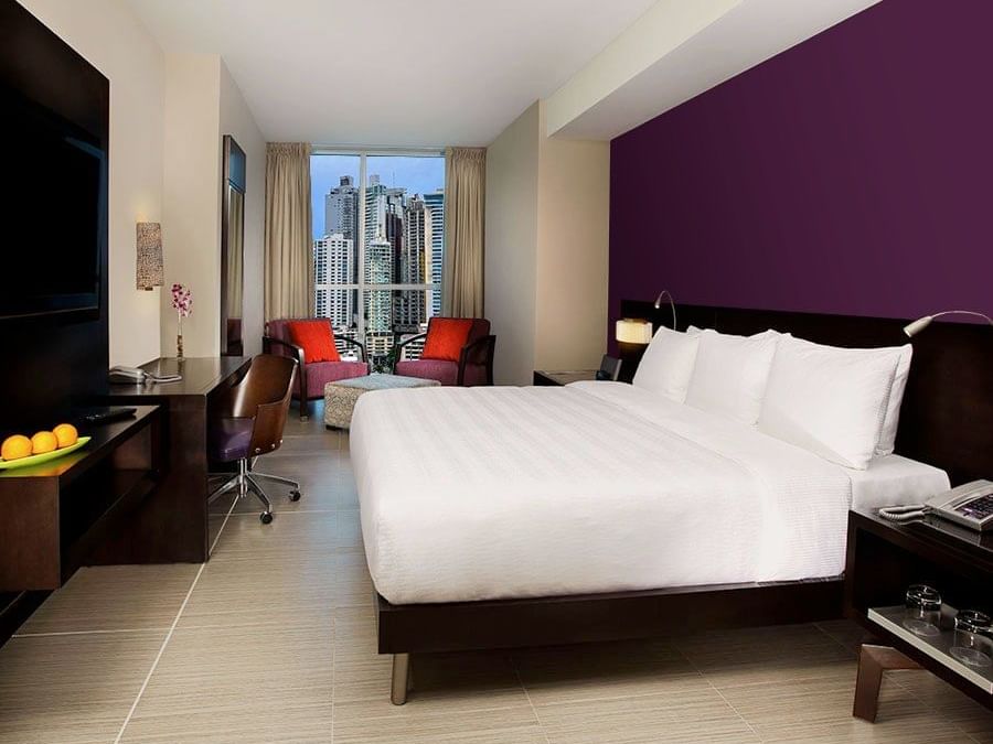 Comfy bed with TV area in 2 Bedroom Suite Gold at Megapolis Hotel Panama