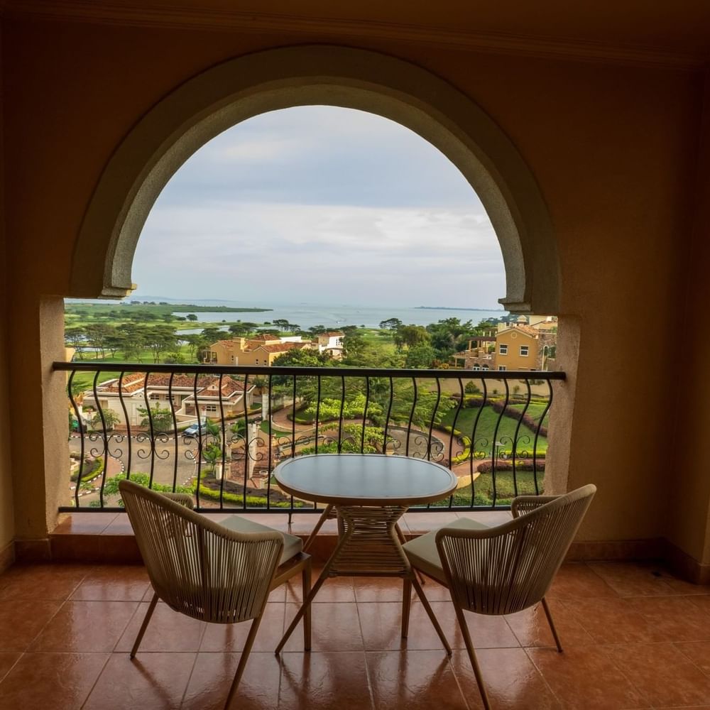 Executive Suite balcony with lake view and table at Lake Victoria Serena Golf Resort & Spa in Kampala.