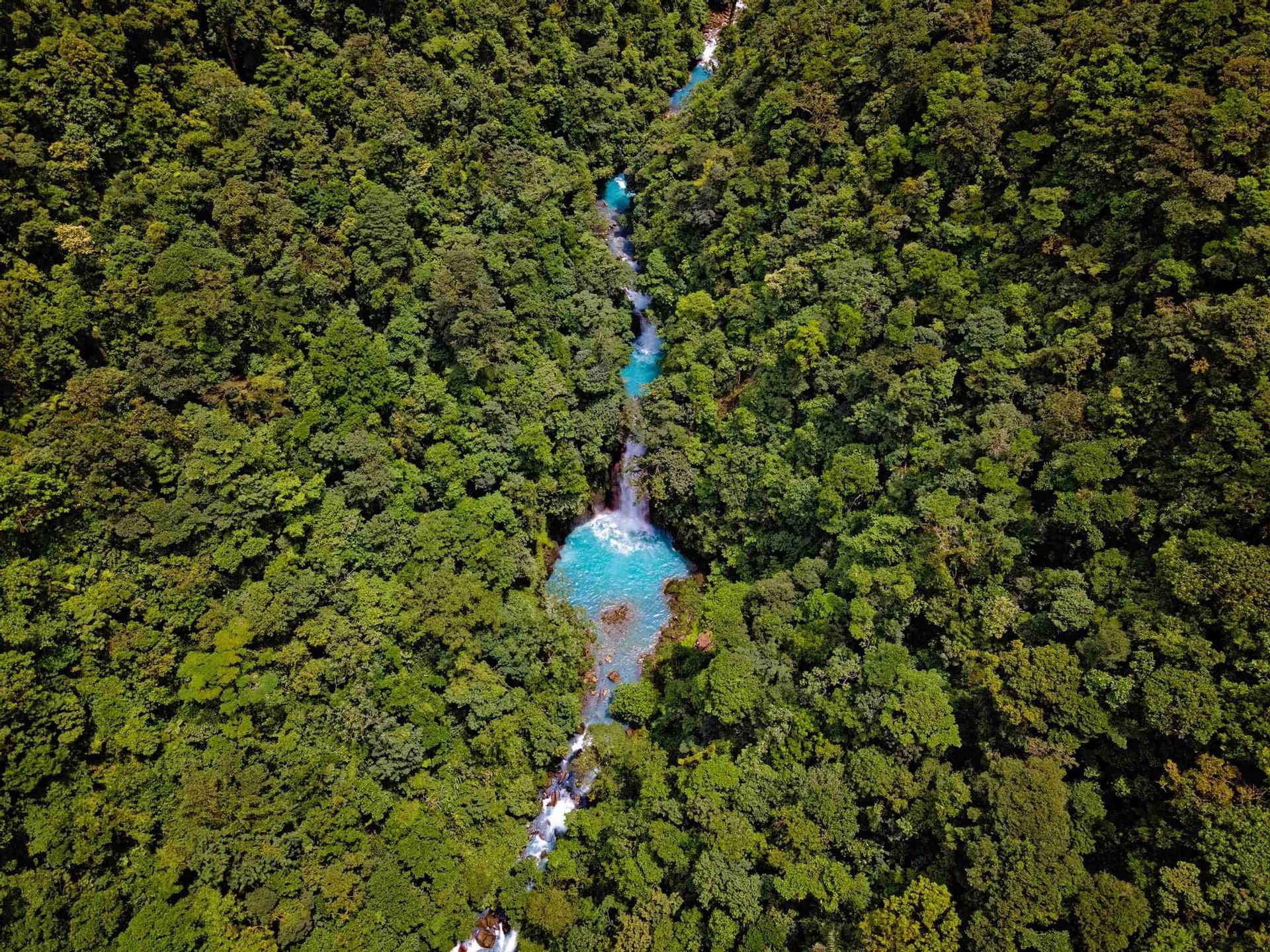 An aerial view of river & forest near the Rio Celeste Hideaway