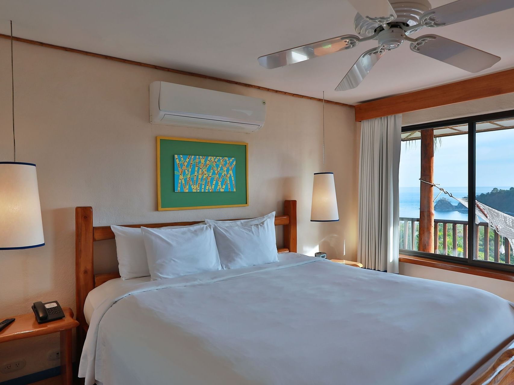 A King bed in The Deluxe King room at Punta Islita Hotel