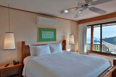Bed & furniture in Deluxe King room at Punta Islita Hotel